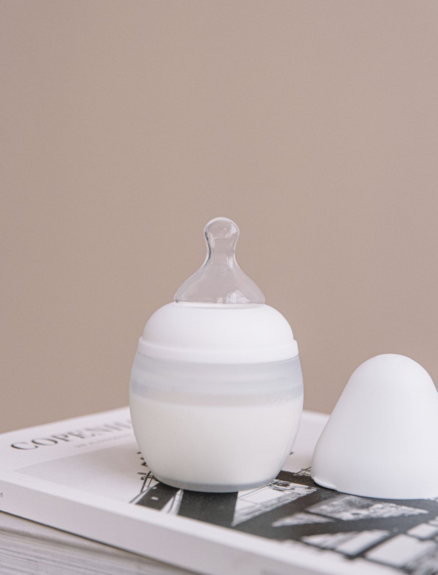 Design minimaliste et poétique du biberon en silicone blanc Élhée dans une chambre
